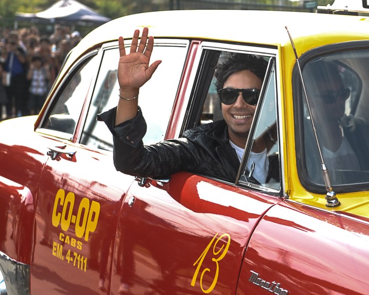 Big Bang Theory actor Kunal Nayyar arrives in a cab at the music launch of his first film, Dr. Cabbie. Photo by Claudio Cugiliari.