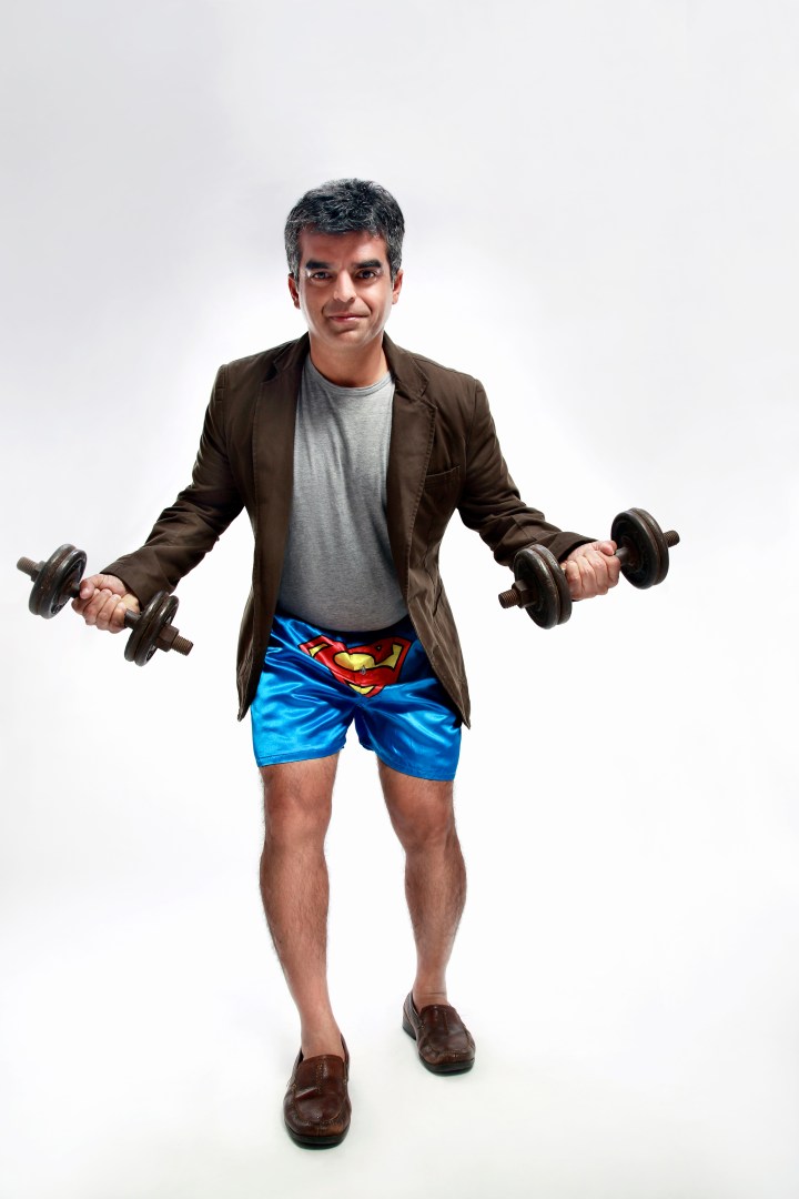 Atul Khatri, wearing underwear with a Superman logo and carrying dumbbells